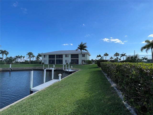 view of dock featuring a yard and a water view