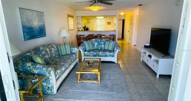 living room featuring tile patterned flooring and ceiling fan