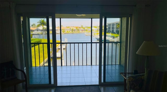 entryway featuring a water view and tile patterned floors