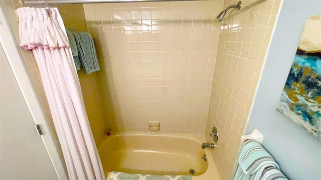 full bathroom with radiator heating unit and shower / bath combination with curtain