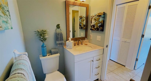 bathroom with tile patterned flooring, vanity, and toilet