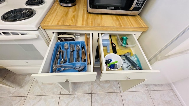 details with stainless steel microwave and white range with electric stovetop