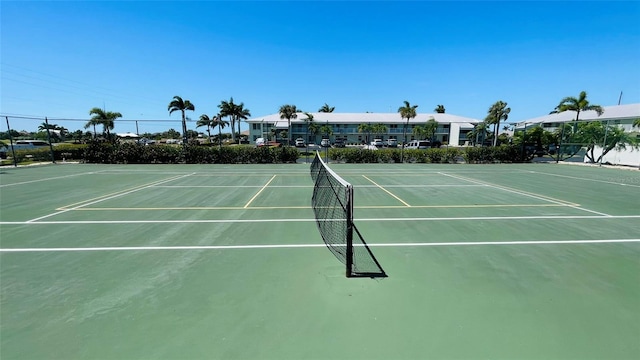 view of tennis court featuring fence