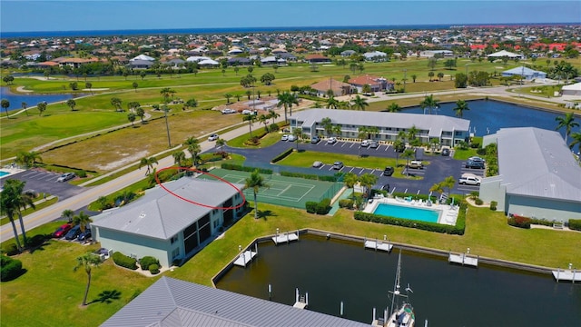 birds eye view of property featuring a water view and a residential view