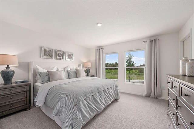 bedroom featuring light colored carpet