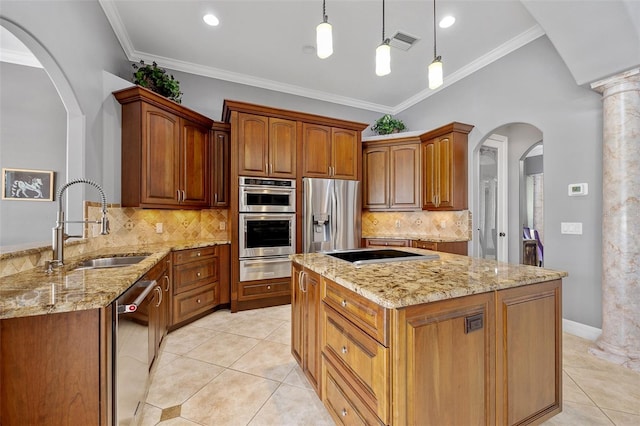 kitchen featuring ornate columns, a center island, pendant lighting, and stainless steel appliances