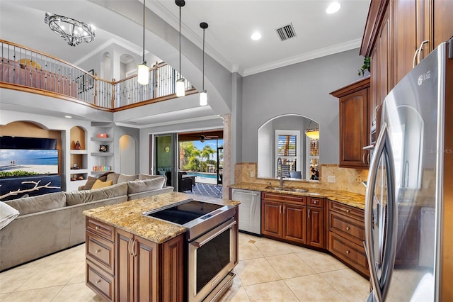 kitchen featuring backsplash, stainless steel appliances, light tile floors, and decorative light fixtures