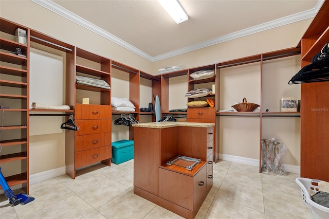 walk in closet with light tile floors