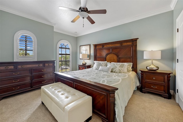 carpeted bedroom featuring ceiling fan and ornamental molding