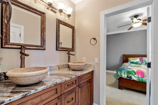 bathroom with crown molding, double vanity, and ceiling fan