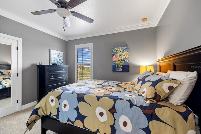 carpeted bedroom featuring ornamental molding and ceiling fan