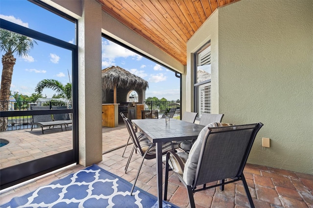 sunroom / solarium featuring wooden ceiling