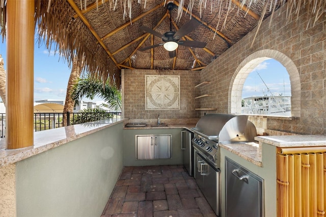 view of terrace featuring area for grilling, ceiling fan, and sink