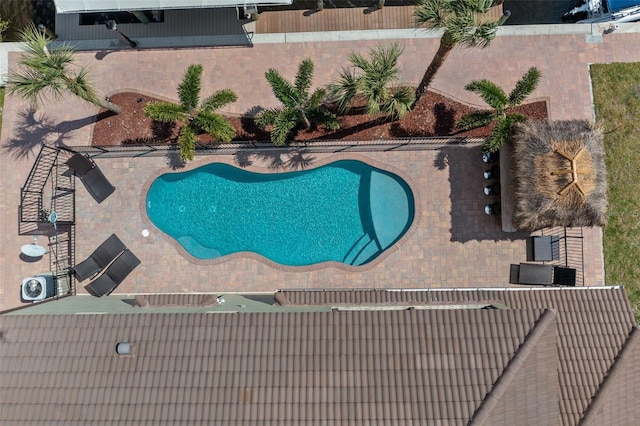 view of swimming pool with central AC unit and a patio