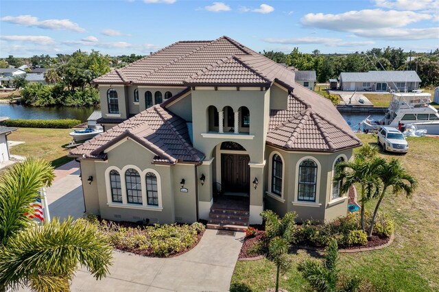 mediterranean / spanish home with a front lawn