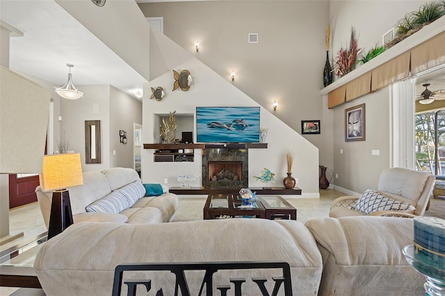 living room featuring tile flooring, high vaulted ceiling, ceiling fan, and a premium fireplace