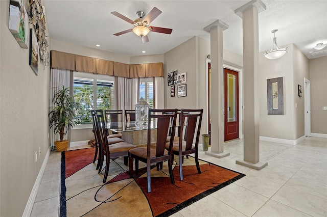 dining space featuring ceiling fan, light tile flooring, and ornate columns