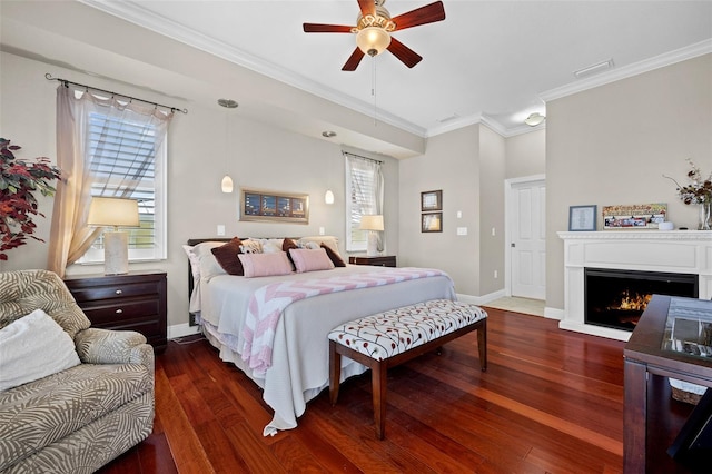 bedroom with ornamental molding, dark wood-type flooring, and ceiling fan