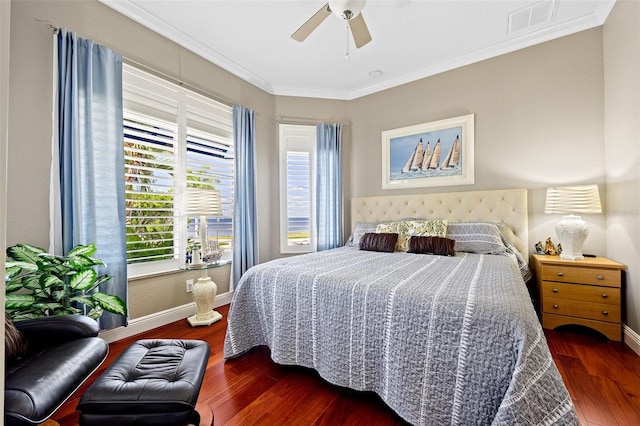 bedroom with ornamental molding, ceiling fan, and dark hardwood / wood-style floors