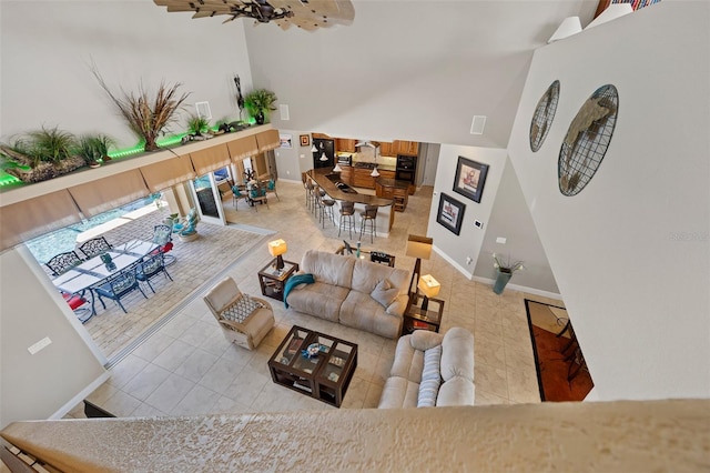 tiled living room featuring a towering ceiling