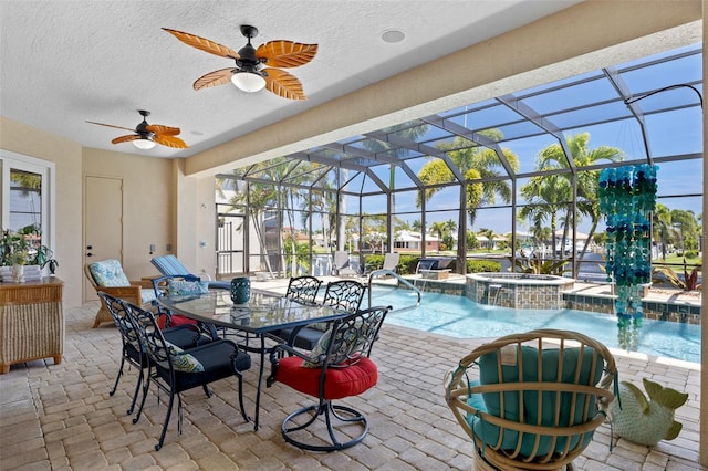 sunroom / solarium featuring ceiling fan, a swimming pool, and plenty of natural light