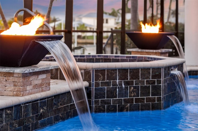 exterior details featuring an outdoor fire pit, a swimming pool, and tile flooring