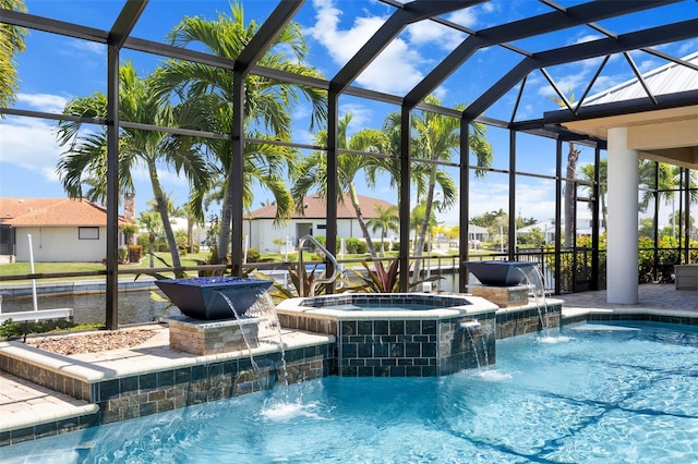 view of swimming pool with pool water feature, an in ground hot tub, and a lanai