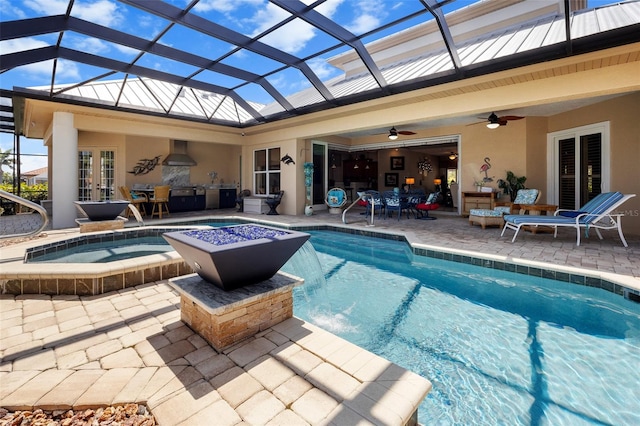 view of swimming pool featuring a patio area, ceiling fan, a lanai, and an in ground hot tub