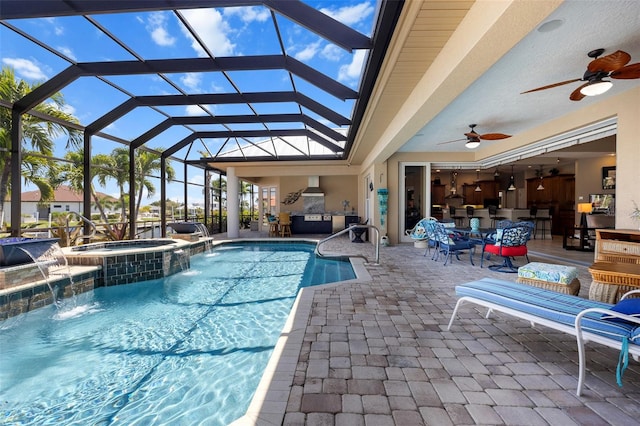 view of pool with a patio, ceiling fan, glass enclosure, and an in ground hot tub