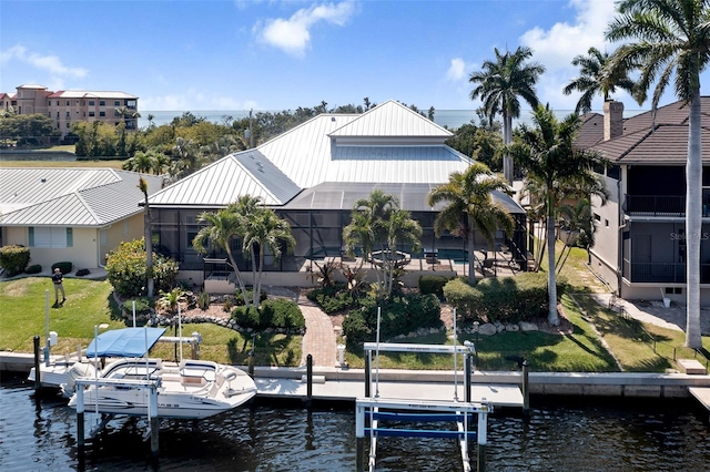 view of dock featuring a water view, a swimming pool, a lanai, and a lawn