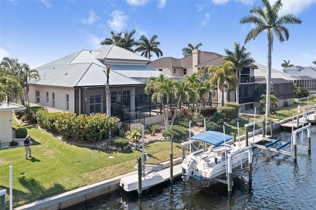 dock area with a lanai, a lawn, and a water view