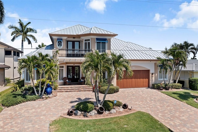 view of front of home with a garage and a balcony