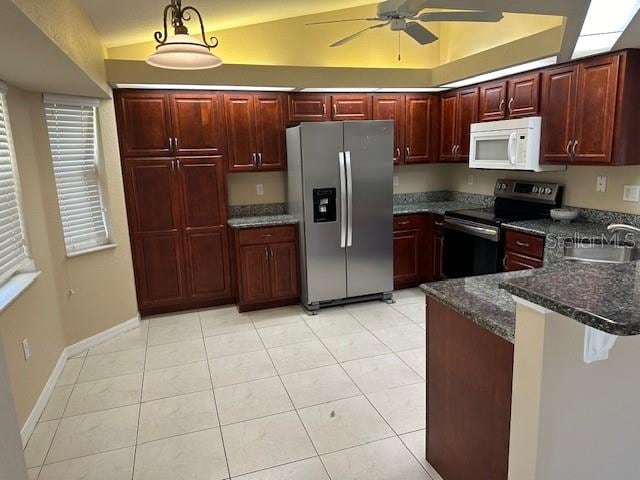 kitchen with appliances with stainless steel finishes, ceiling fan, dark stone counters, sink, and light tile floors