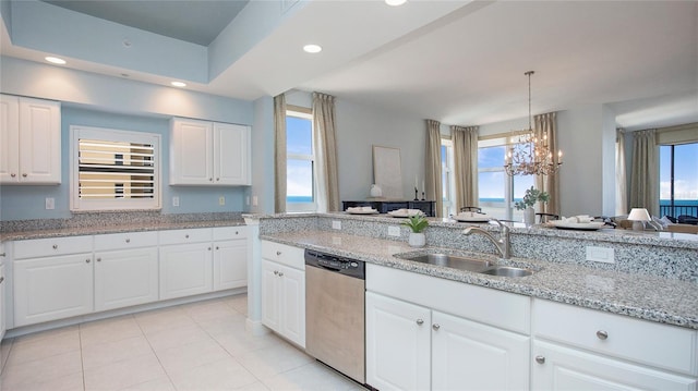 kitchen with white cabinets, dishwasher, light tile floors, and a wealth of natural light