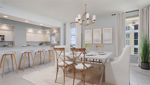 dining area with a notable chandelier and light tile floors