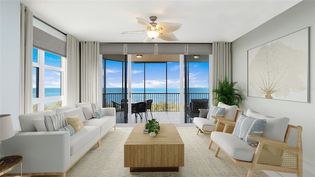 living room featuring a water view, ceiling fan, and expansive windows