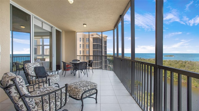 sunroom / solarium with a water view