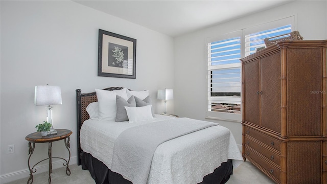 bedroom featuring light colored carpet