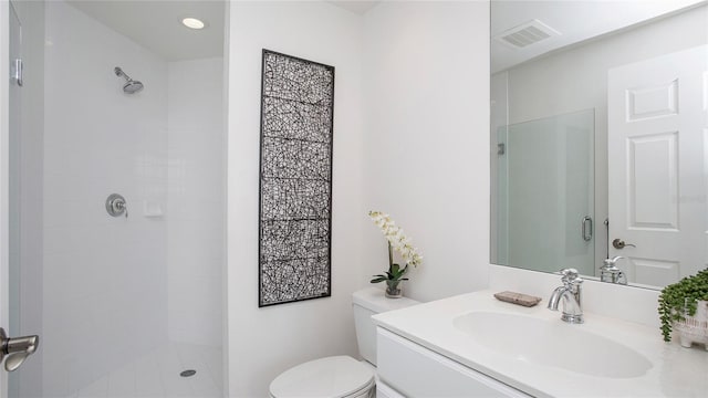 bathroom with oversized vanity, tiled shower, and toilet