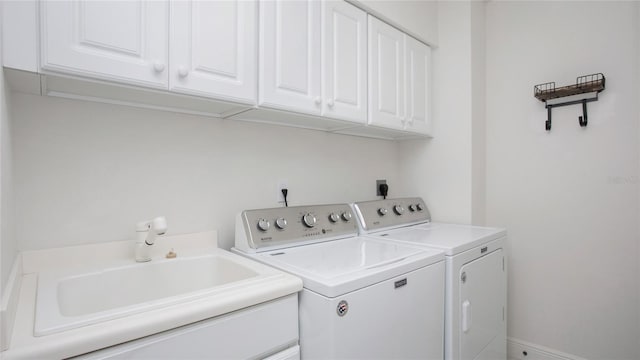 clothes washing area with cabinets, sink, washer and dryer, and electric dryer hookup