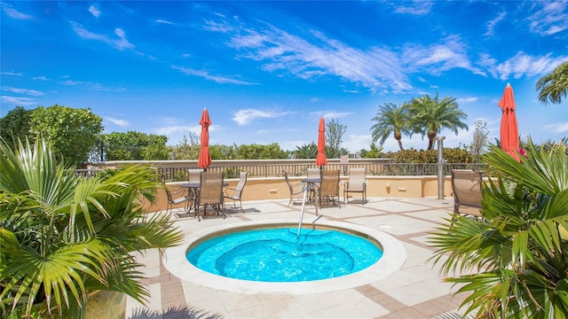 view of pool featuring a patio and an in ground hot tub