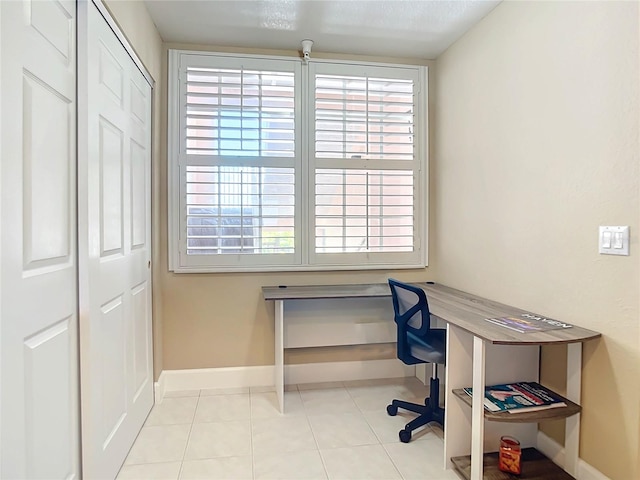 tiled home office with a healthy amount of sunlight