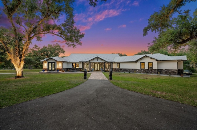 ranch-style home featuring a yard