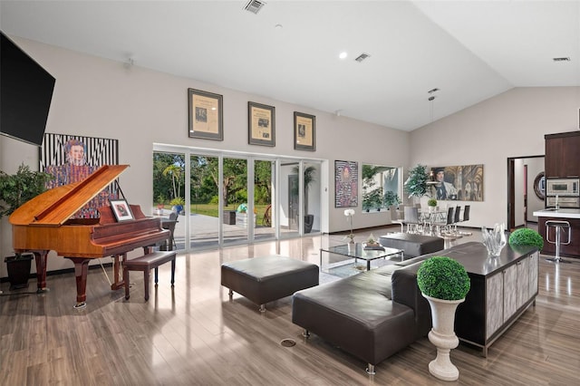 interior space with high vaulted ceiling and hardwood / wood-style flooring