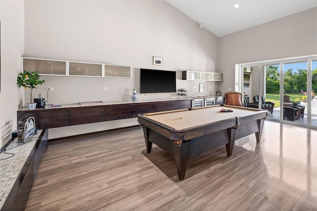 interior space featuring light hardwood / wood-style flooring, high vaulted ceiling, and billiards