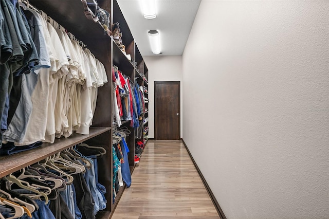 spacious closet with light hardwood / wood-style floors