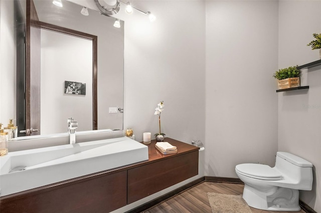 bathroom featuring oversized vanity, hardwood / wood-style floors, and toilet