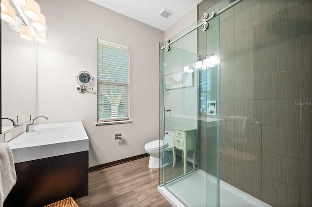 bathroom with hardwood / wood-style flooring, toilet, and vanity