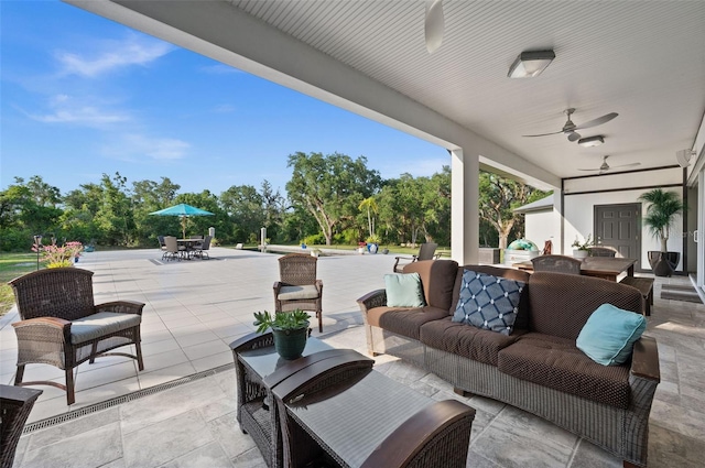 view of patio with an outdoor living space and ceiling fan