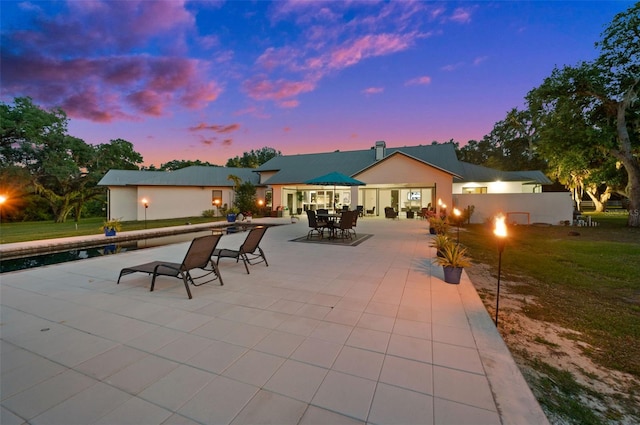 exterior space with a patio area and a lawn